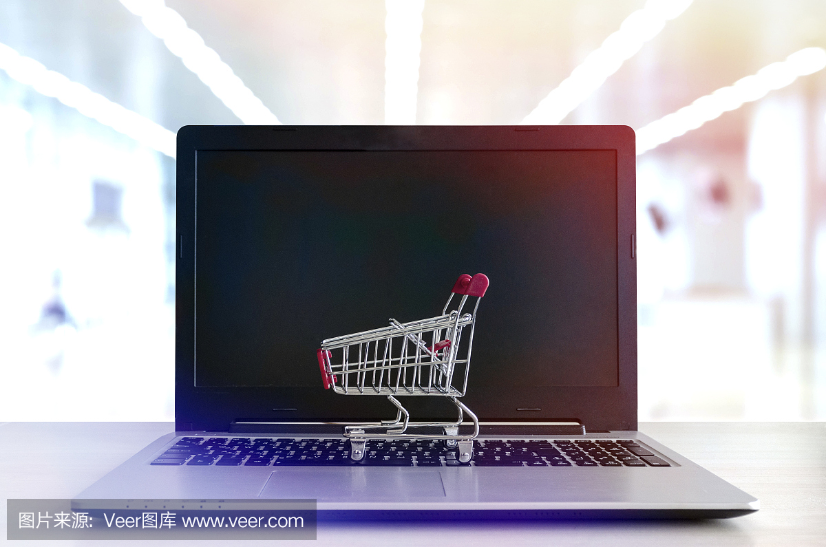 網(wǎng)上購(gòu)物概念:筆記本電腦上的迷你購(gòu)物車(chē)